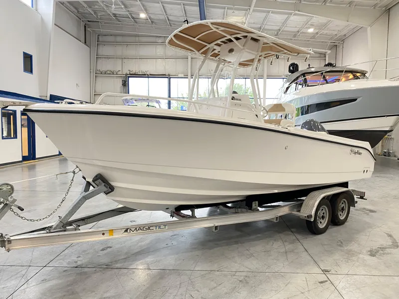 Slide: The Image of 2023 Edgewater 208CC boat on trailer in indoor showroom. - 1