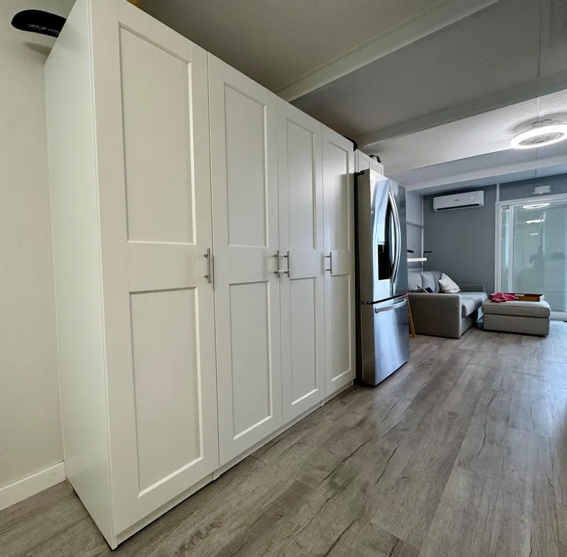 Slide: The Image of Modern kitchen with white cabinets, stainless steel fridge, and sleek flooring, 2023 Modern Struktures MS 400. - 14