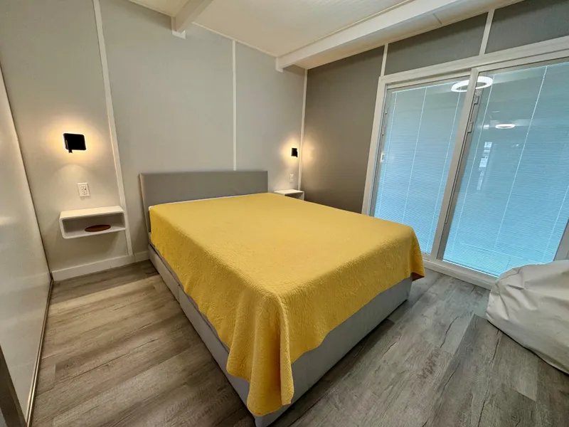 Slide: The Image of Modern bedroom with yellow bedspread, sleek design, and ambient lighting, 2023 Modern Struktures MS 400. - 16