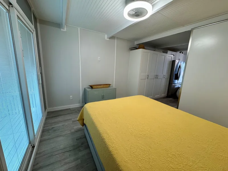 Slide: The Image of Modern bedroom with yellow bedding, sleek design, and ample storage in a 2023 Modern Struktures MS 400. - 17