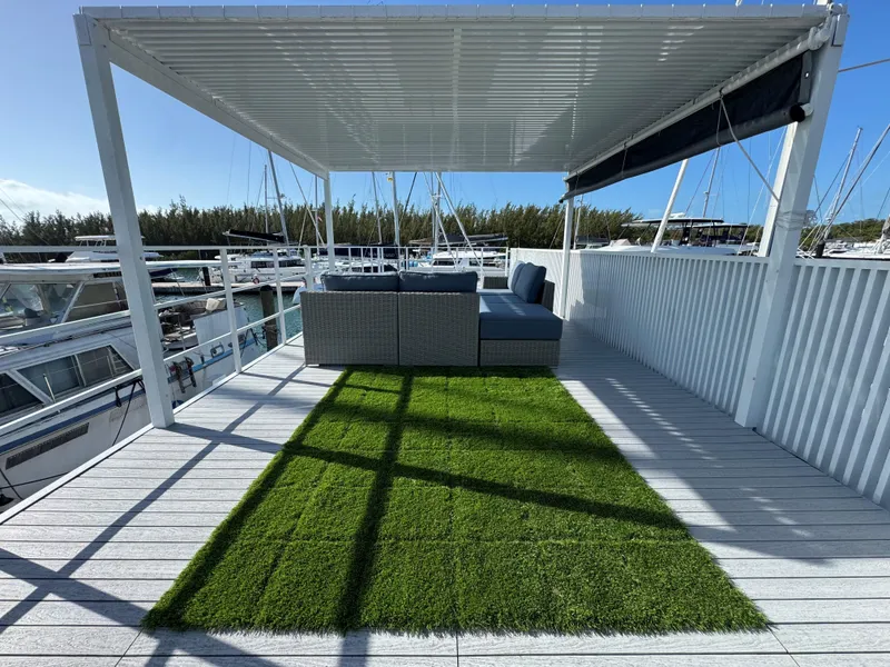 Slide: The Image of Modern Struktures MS 400 rooftop deck with pergola, artificial grass, and outdoor seating, 2023 model. - 26