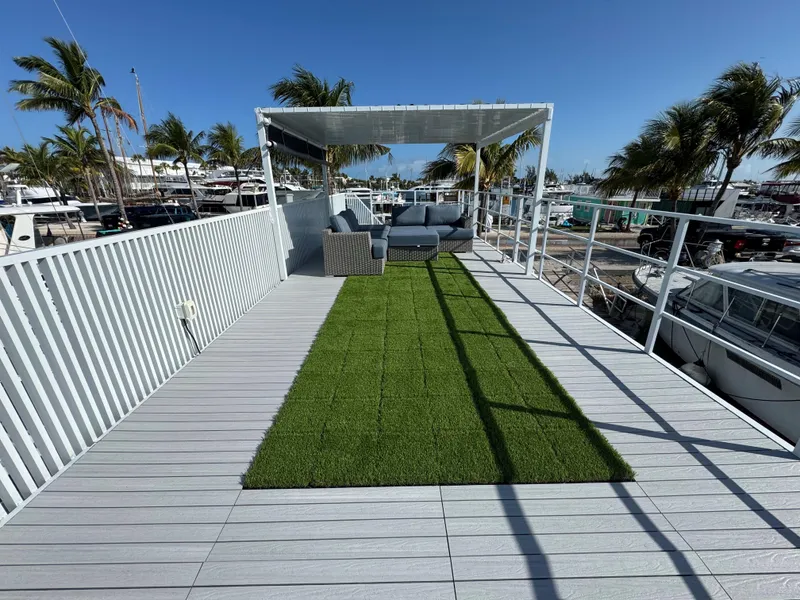 Slide: The Image of Rooftop deck with artificial grass, modern seating, and palm trees, by Modern Struktures MS 400, 2023. - 27