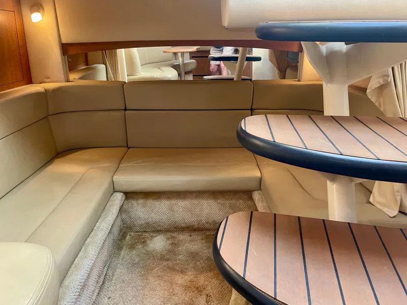 Slide: The Image of Interior of 2006 Sea Ray 320 Sundancer yacht with beige seating and wooden steps. - 12