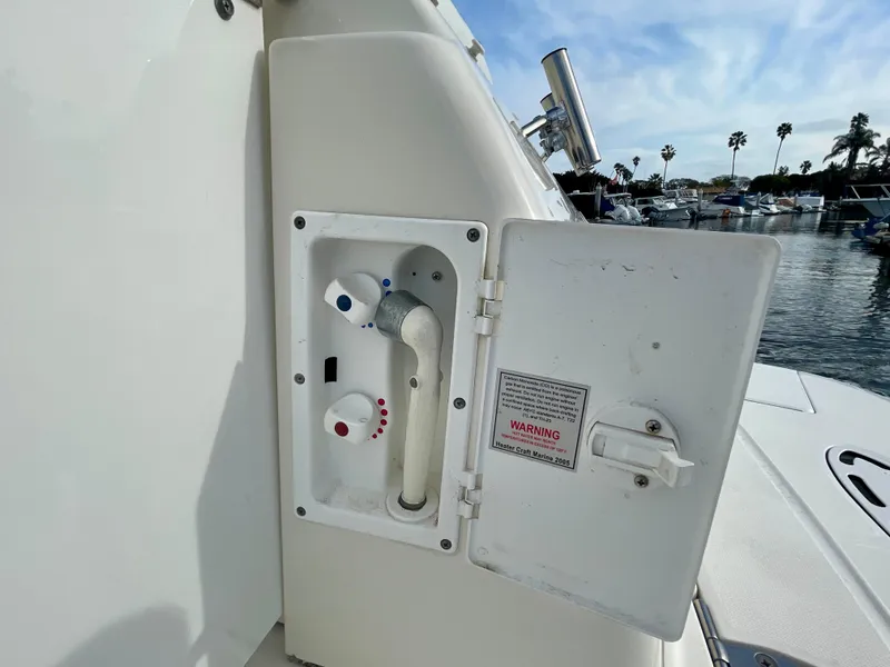 Slide: The Image of Sea Ray 320 Sundancer 2006 boat water hookup compartment with open access panel. - 33
