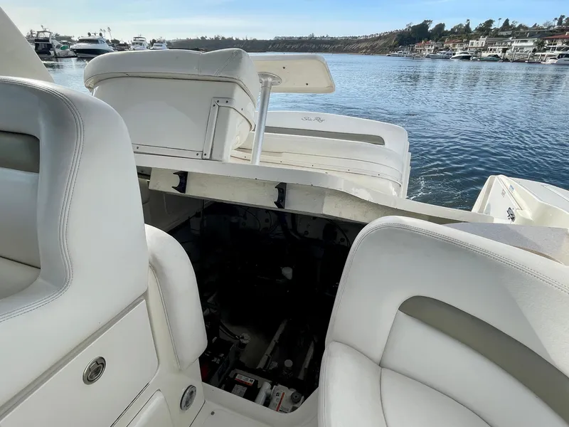 Slide: The Image of 2006 Sea Ray 320 Sundancer interior with open engine compartment, docked by the water. - 34