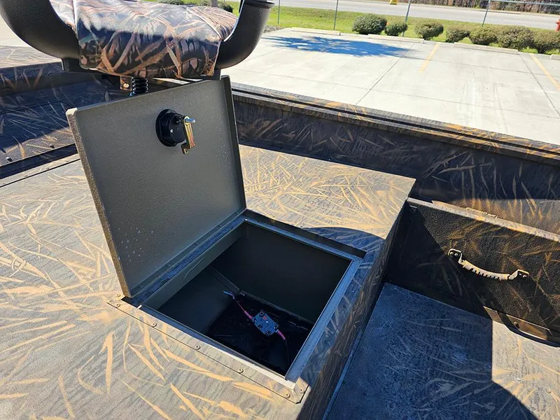 Slide: The Image of 2025 G3 Gator Tough 18 DK boat with open storage compartment and camo seat. - 10