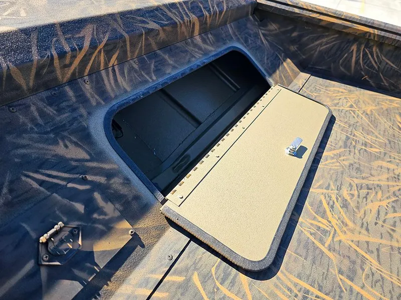Slide: The Image of 2025 G3 Gator Tough 18 DK boat storage compartment with camo design. - 23
