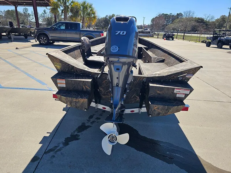 Slide: The Image of 2025 G3 Gator Tough 18 DK boat with 70 HP motor in parking lot. - 3