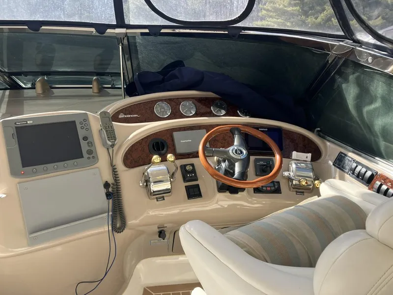 Slide: The Image of 2004 Sea Ray 460 Sundancer helm with steering wheel, controls, and navigation equipment. - 11