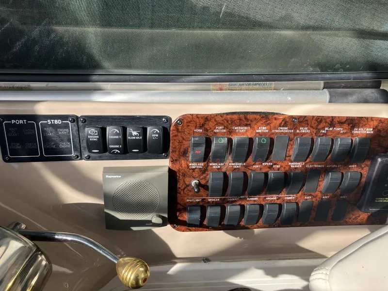 Slide: The Image of Control panel of a 2004 Sea Ray 460 Sundancer boat with switches and speaker. - 12