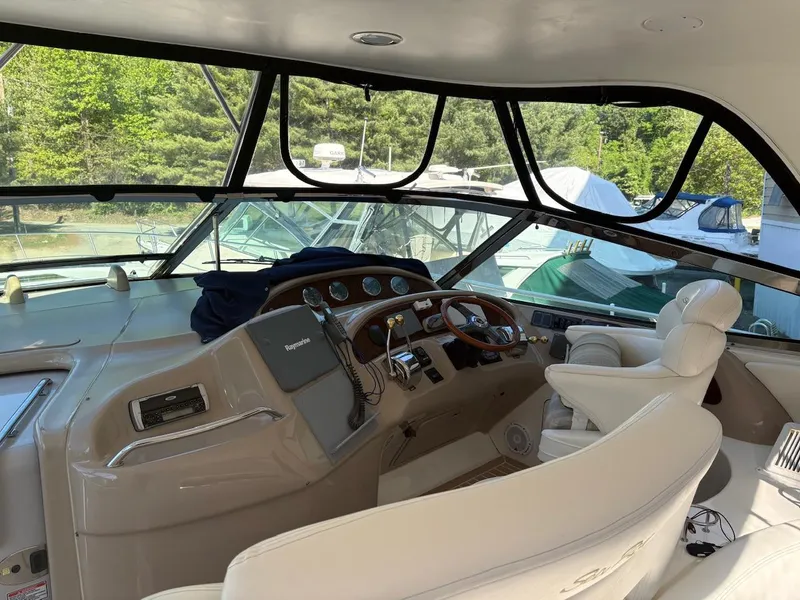 Slide: The Image of 2004 Sea Ray 460 Sundancer yacht cockpit with luxurious seating and modern controls. - 13