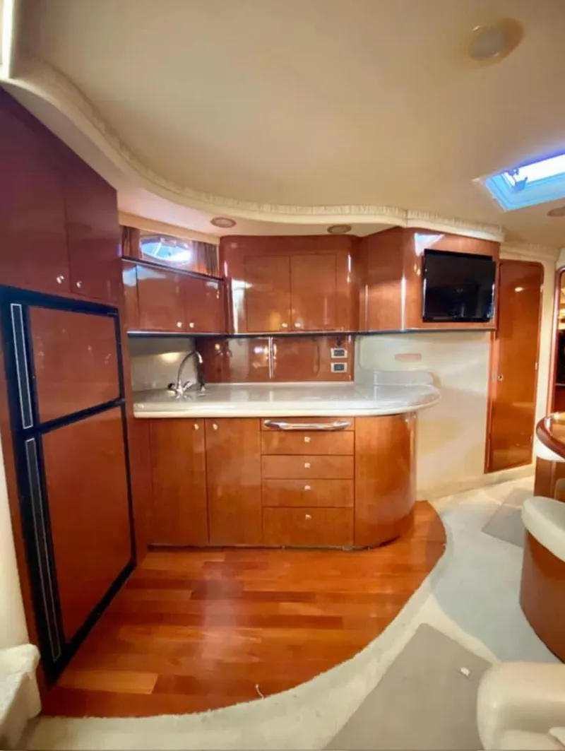 Slide: The Image of Luxurious 2004 Sea Ray 460 Sundancer yacht interior with modern kitchen and wood cabinetry. - 18