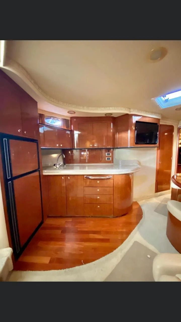 Slide: The Image of Luxurious interior of 2004 Sea Ray 460 Sundancer yacht with modern kitchen amenities. - 20