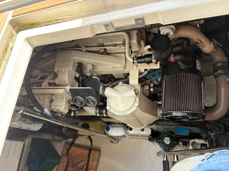 Slide: The Image of Engine compartment of a 2004 Sea Ray 460 Sundancer boat, showcasing mechanical components. - 25