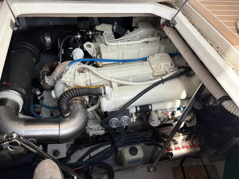 Slide: The Image of Engine compartment of a 2004 Sea Ray 460 Sundancer boat, showcasing mechanical components. - 26