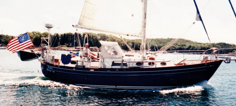 The Image of Sailing yacht "Fantasia C/C Double Ended Cutter" 1978 on water with American flag. - 0