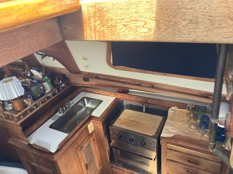 Slide: The Image of Vintage 1978 Custom Fantasia yacht kitchen with wooden cabinetry and compact appliances. - 10