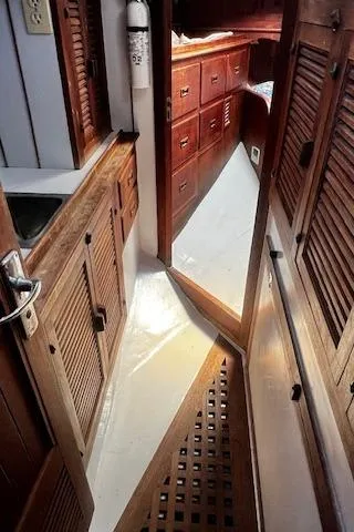 Slide: The Image of Interior of 1978 Custom Fantasia C/C Double Ended Cutter with wooden cabinetry and flooring. - 11