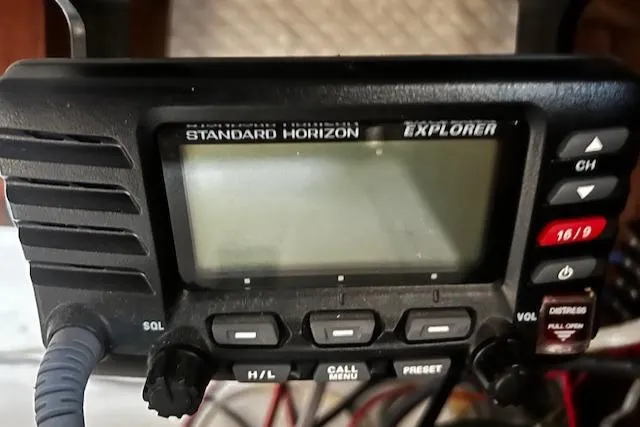 Slide: The Image of Standard Horizon Explorer marine radio with buttons and display, mounted on a boat. - 18