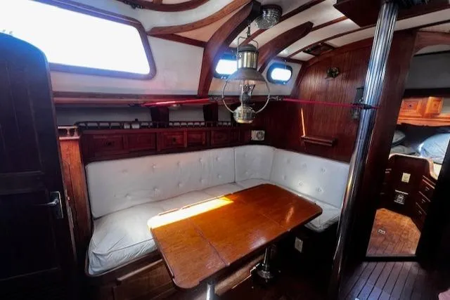 Slide: The Image of Interior of 1978 Custom Fantasia C/C Double Ended Cutter with wooden table and cushioned seating. - 2
