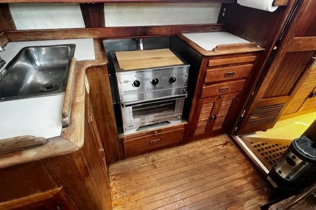 Slide: The Image of 1978 Custom Fantasia C/C Double Ended Cutter kitchen with wooden cabinetry and stainless steel appliances. - 22