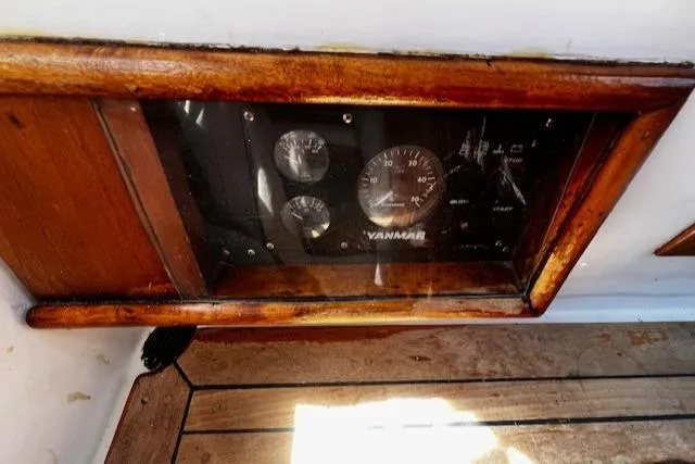 Slide: The Image of Wooden dashboard with Yanmar gauges on 1978 Custom Fantasia C/C Double Ended Cutter. - 23