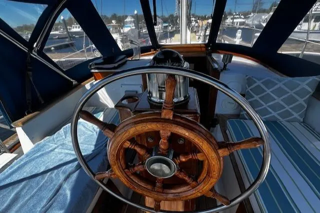 Slide: The Image of 1978 Custom Fantasia C/C Double Ended Cutter yacht helm with wooden wheel and nautical decor. - 25