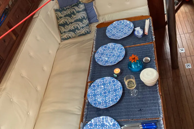 Slide: The Image of Cozy dining setup on a 1978 Custom Fantasia C/C Double Ended Cutter sailboat. - 3