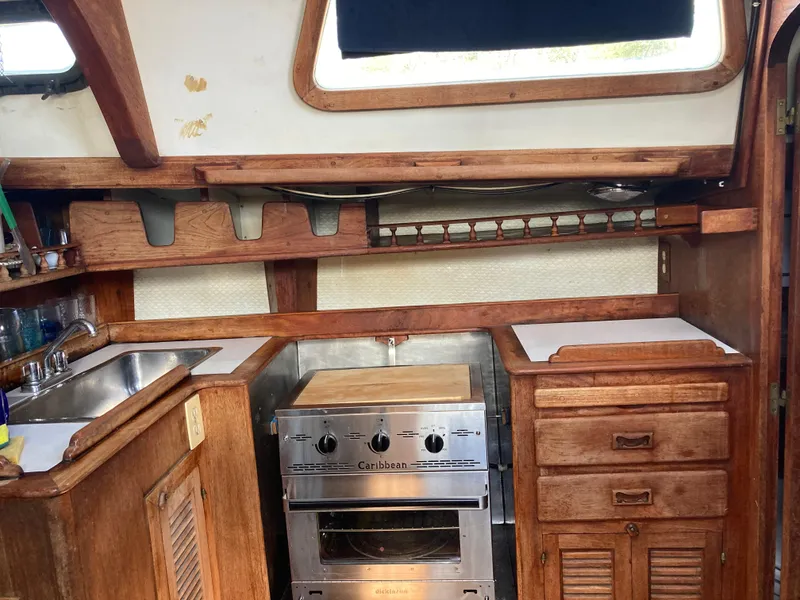 Slide: The Image of 1978 Custom Fantasia C/C Double Ended Cutter kitchen with wooden cabinets and stainless steel stove. - 4