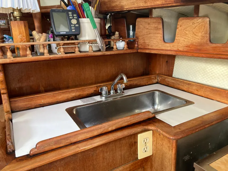 Slide: The Image of Wooden boat kitchen with sink, shelves, and navigation equipment, 1978 Custom Fantasia C/C Cutter. - 5