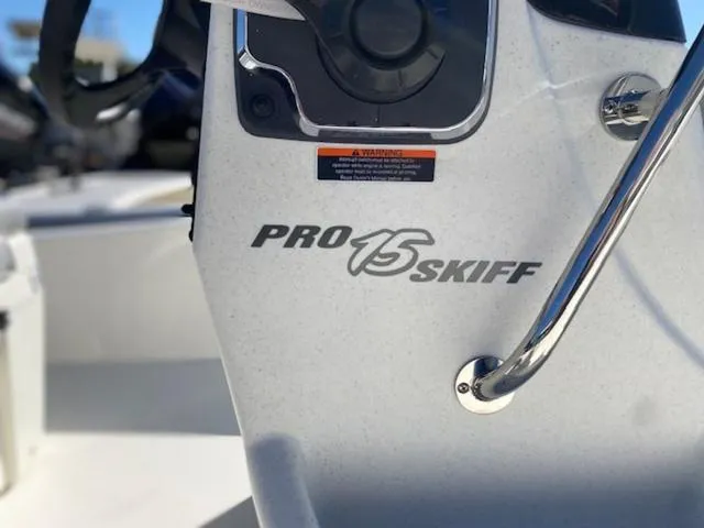 Slide: The Image of 2025 Mako Pro Skiff 15 CC console with logo and steering wheel detail. - 3