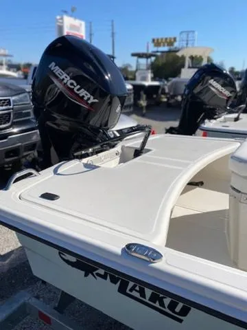 Slide: The Image of 2025 Mako Pro Skiff 15 CC with Mercury outboard motor in a dealership lot. - 6
