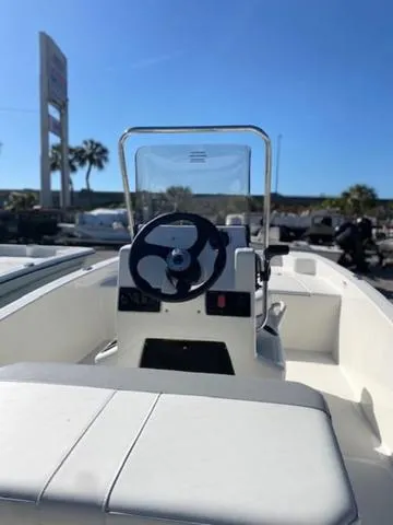 Slide: The Image of 2025 Mako Pro Skiff 15 CC boat with steering console, outdoor setting. - 7