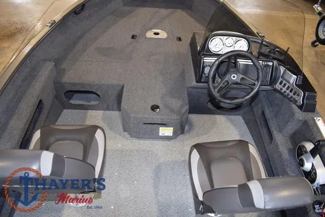 Slide: The Image of 2022 Lund 1675 Adventure Sport boat interior with steering wheel and seating. - 13