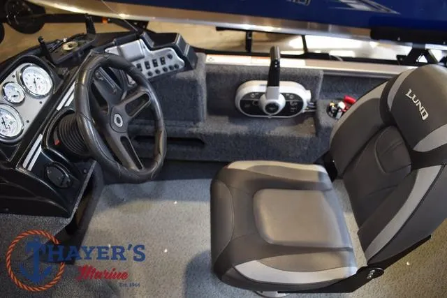 Slide: The Image of 2022 Lund 1675 Adventure Sport boat interior with steering wheel and seat. - 16