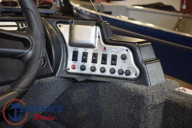 Slide: The Image of Control panel of 2022 Lund 1675 Adventure Sport boat with switches and buttons. - 19