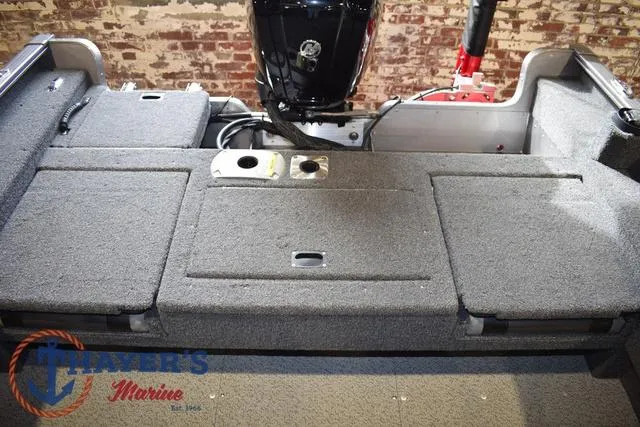 Slide: The Image of 2022 Lund 1675 Adventure Sport boat interior with carpeted deck and motor. - 23