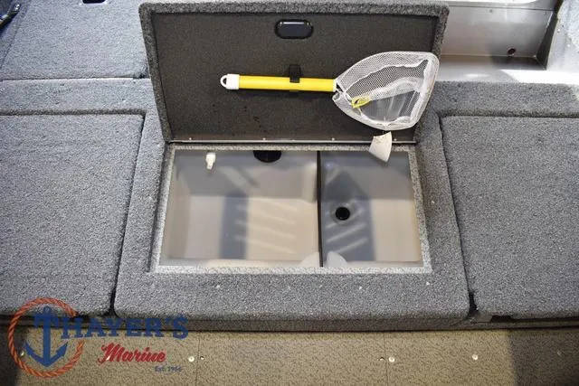 Slide: The Image of 2022 Lund 1675 Adventure Sport boat storage compartment with net, Thayer's Marine logo. - 24