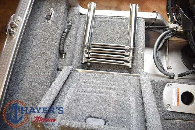 Slide: The Image of 2022 Lund 1675 Adventure Sport boat interior with folded ladder and storage compartments. - 25