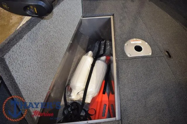 Slide: The Image of Storage compartment in 2022 Lund 1675 Adventure Sport boat with safety equipment. - 27