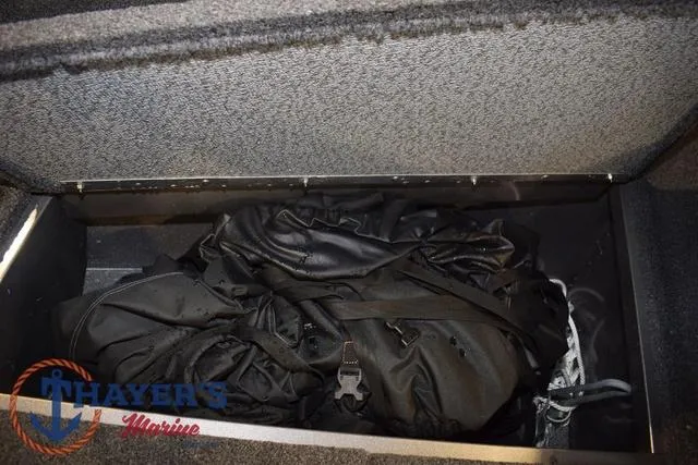 Slide: The Image of 2022 Lund 1675 Adventure Sport storage compartment with black gear inside. - 28