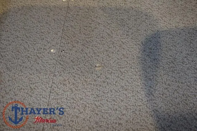 Slide: The Image of Carpeted floor of 2022 Lund 1675 Adventure Sport boat, featuring Thayer's Marine logo. - 30