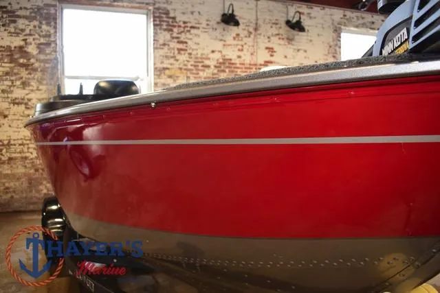 Slide: The Image of 2022 Lund 1675 Adventure Sport boat with red exterior in showroom. - 34