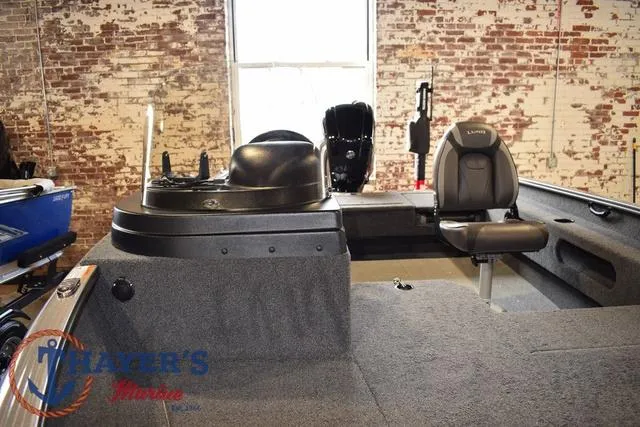 Slide: The Image of 2022 Lund 1675 Adventure Sport boat interior with seating and control console. - 8