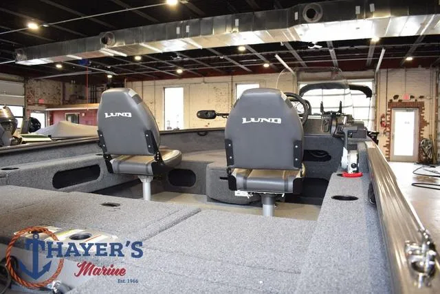 Slide: The Image of 2022 Lund 1675 Adventure Sport boat interior with seating, displayed at Thayer's Marine showroom. - 9