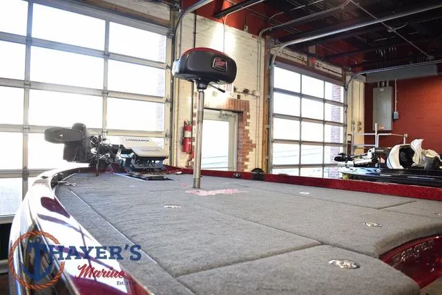 Slide: The Image of 2017 Ranger Z521C boat interior in a garage, featuring fishing equipment and Thayer's Marine logo. - 12