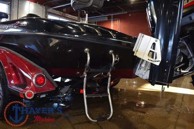 Slide: The Image of 2017 Ranger Z521C boat with ladder and motor, displayed indoors at Thayer's Marine. - 13