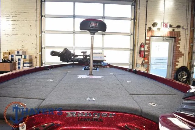 Slide: The Image of 2017 Ranger Z521C boat interior with fishing deck and equipment in a garage setting. - 14