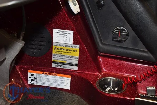 Slide: The Image of 2017 Ranger Z521C boat interior with capacity warning labels and control panel. - 25