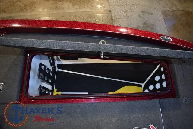 Slide: The Image of 2017 Ranger Z521C boat storage compartment with organized interior and Thayer's Marine logo. - 30
